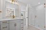 primary bath with a large walk-in closet