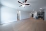 open great room with wood floors and ceiling fan