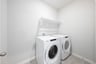 laundry room with tile floors, washer, and dryer