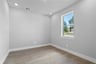 spacious study with hardwood flooring and windows