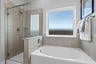primary bathroom with soaking tub and walk-in shower
