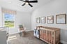 guest bedroom with window and carpet