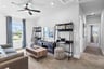 open loft with carpet and windows