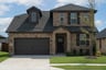 two-story home with brick and shutters