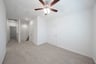 open gameroom with carpet and ceiling fan