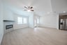open great room with wood floors and fireplace