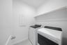 laundry room with tile floors, washer, and dryer