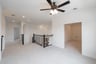 open gameroom with carpet and ceiling fan