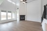 open great room with wood floors and fireplace