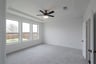 primary bedroom with carpet and ceiling fan