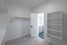  primary bedroom closet with carpet and white shelves