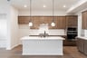 open kitchen with wood floors and island
