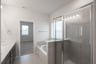 primary bathroom with soaking tub and walk-in shower