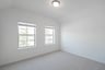 bedroom with two windows with window blinds 