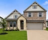Home with brick, windows and ladscaping