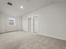 loft with carpet, window and entrance to bedrooms