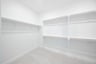 primary bedroom closet with carpet and white shelves