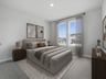 bedroom with carpet, windows and sloped ceiling 