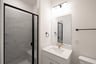 bathroom with walk-in shower and white countertops 