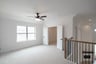 game room with large window and ceiling fan 