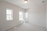bedroom with carpet and windows 