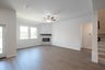 great room with fireplace and ceiling fan 