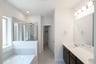 bathroom with tub and walk-in shower