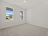 secondary bedroom with carpet and windows