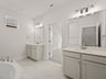 primary bath with dual sinks, soaking tub and walk in shower