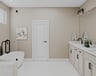 primary bathroom with white cabinets and tile flooring