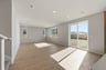 great room with light wood floors, multiple windows, sliding glass door that leads to backyard, and recessed ceiling lights