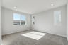 bedroom with gray carpet, white walls, multiple windows, and recessed ceiling lights