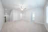 open gameroom with carpet and ceiling fan