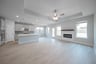 open great room with wood floors and fireplace
