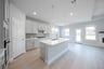 open kitchen with wood floors and island