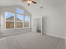 primary bedroom with carpet, windows and a ceiling fan