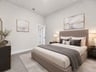 secondary bedroom with carpet, window and sloped ceilings 