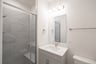 bathroom with walk-in shower and white countertops 