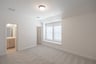 room with carpet and large windows with window seat 