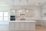 kitchen with white countertops and wood flooring 