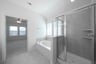 primary bathroom with walk-in shower and soaking tub
