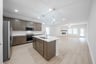 open kitchen with wood floors and island