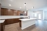 open kitchen with wood floors and island