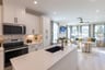 white kitchen overlooks the open great room