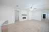 open great room with wood floors and fireplace