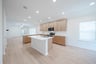 open kitchen with wood floors and island