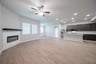 open great room with wood floors and ceiling fan