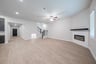 open great room with wood floors and ceiling fan