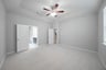 primary bedroom with carpet and ceiling fan