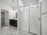bathroom with a walk-in shower & quartz countertops